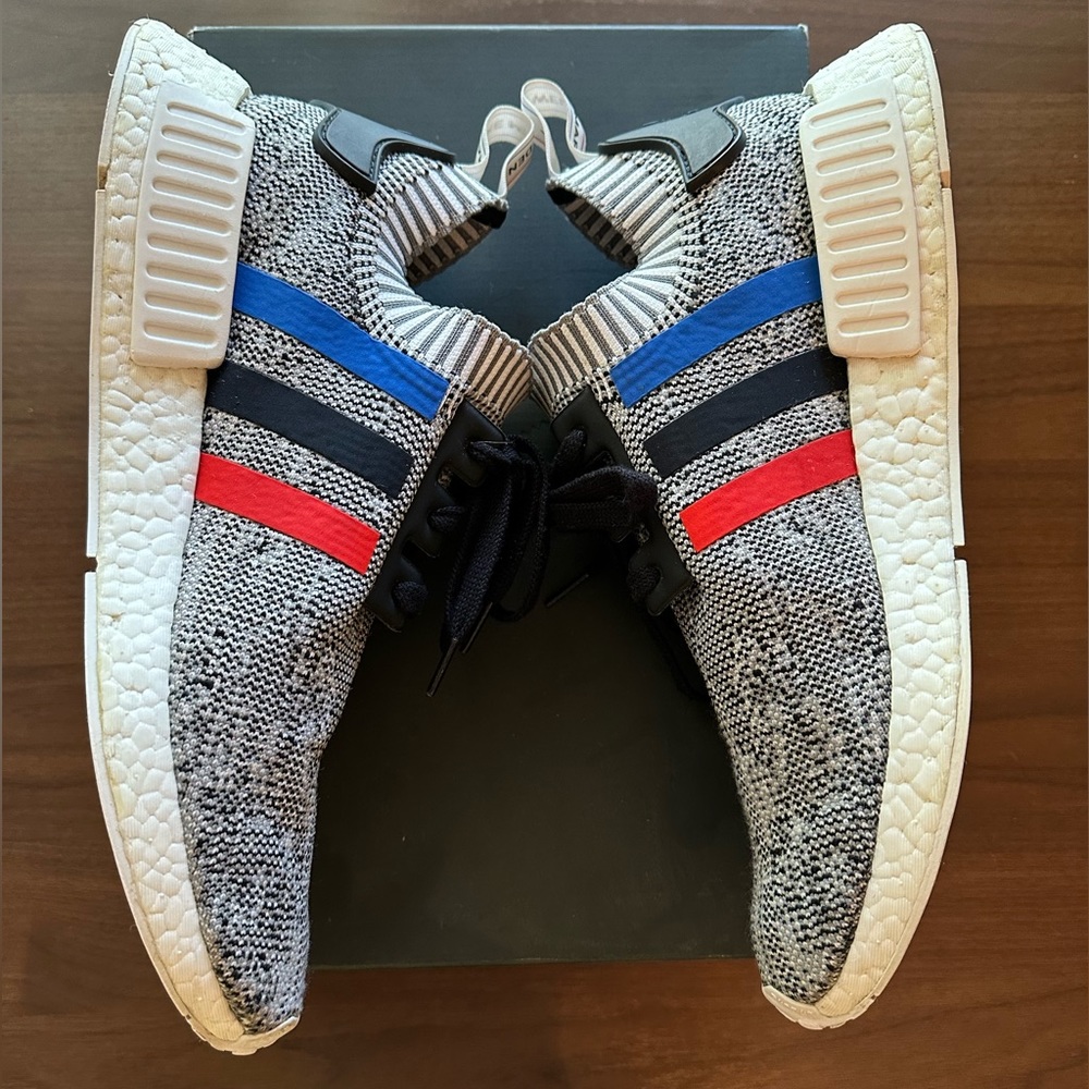Adidas NMD R1 PK Men’s Grey Sneakers with Blue, black and Red Stripes.